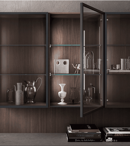 Pedini closet design with wood veneer and glass shelving displaying decorative objects and books.